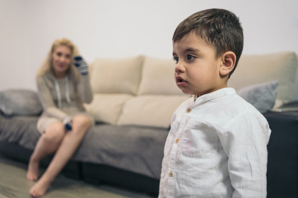 Fiatal autista gyerek, akit elterel a tévé, figyelmen kívül hagyva középkorú édesanyját,